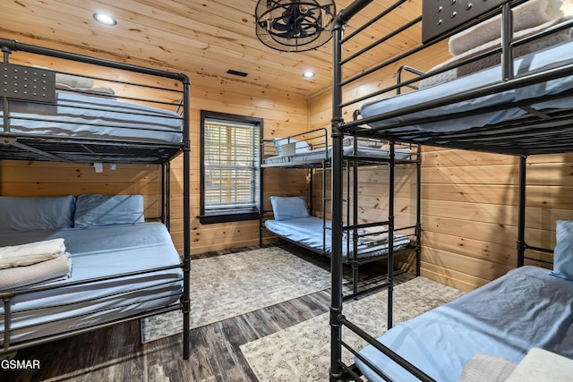 bedroom with recessed lighting, wooden walls, wood finished floors, and wooden ceiling