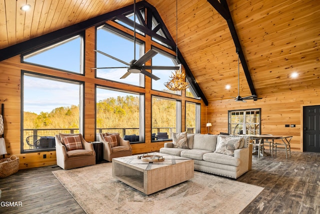 living area with beam ceiling, wooden walls, wood finished floors, and wood ceiling