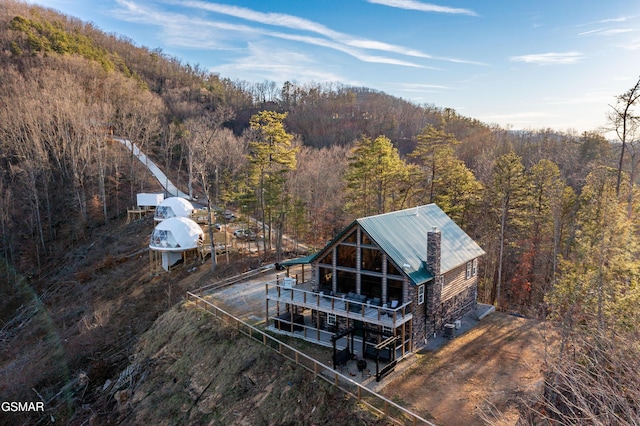 birds eye view of property with a forest view