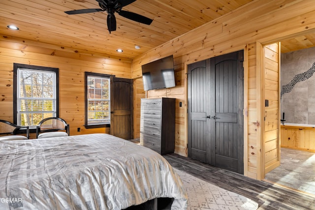 bedroom featuring wooden ceiling, wooden walls, recessed lighting, and wood finished floors