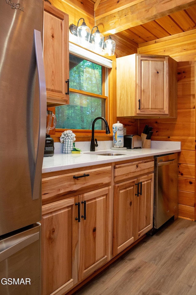 2069 Little Creek Way, Sevierville, TN 37862 - kitchen with appliances with stainless steel finishes, a sink, light wood-style flooring, beamed ceiling, and light countertops