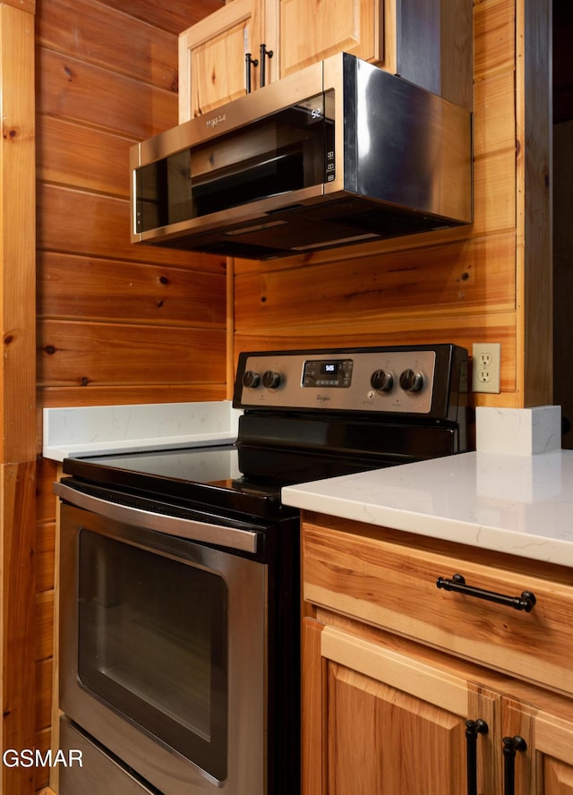 2069 Little Creek Way, Sevierville, TN 37862 - kitchen featuring appliances with stainless steel finishes, wood walls, and light countertops