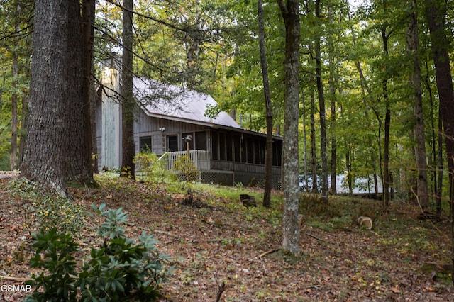 2069 Little Creek Way, Sevierville, TN 37862 - back of property with a sunroom, a wooded view, and metal roof