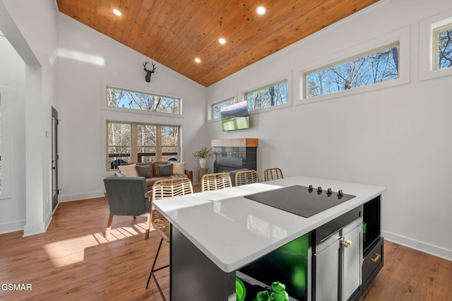 2385 Forge Hideaway Loop Unit 4, Pigeon Forge, TN 37863 - kitchen featuring wood ceiling, recessed lighting, black electric stovetop, plenty of natural light, and baseboards