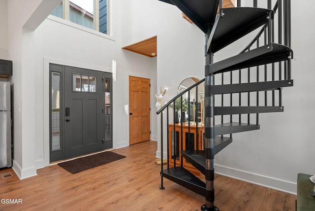 2385 Forge Hideaway Loop Unit 4, Pigeon Forge, TN 37863 - foyer entrance featuring stairway, baseboards, wood finished floors, and a towering ceiling
