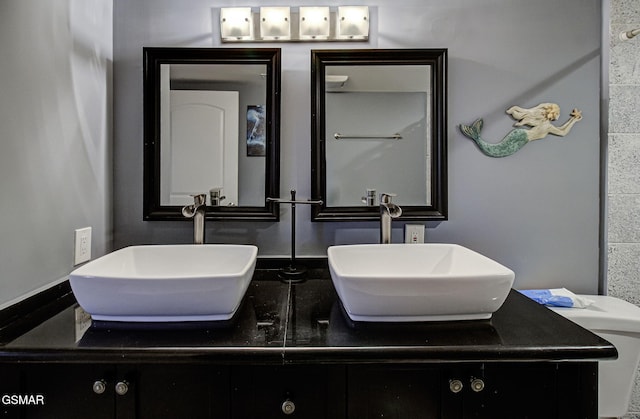 bathroom featuring double vanity and a sink