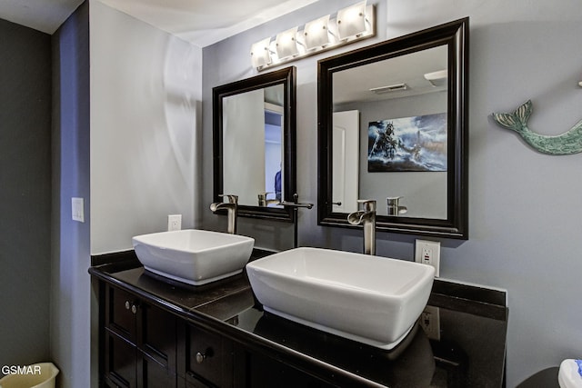 bathroom featuring a sink, visible vents, and double vanity