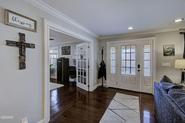 foyer featuring ornamental molding, baseboards, and wood finished floors