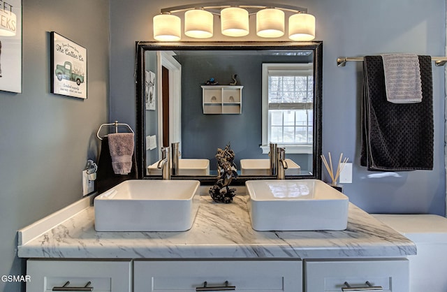 full bath with double vanity and a sink