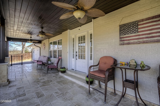 view of patio featuring a ceiling fan and fence