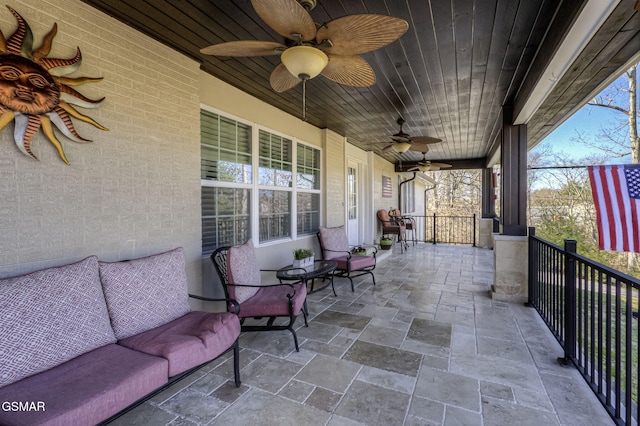 view of patio with a lanai and a ceiling fan