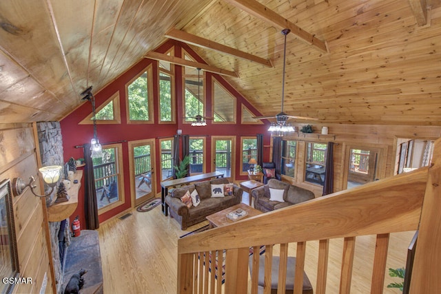 living room featuring a healthy amount of sunlight, wood-type flooring, and wooden ceiling