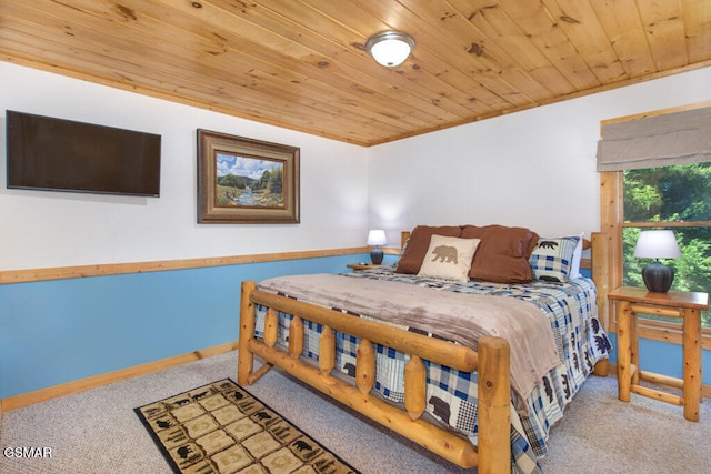 bedroom with wooden ceiling and carpet flooring