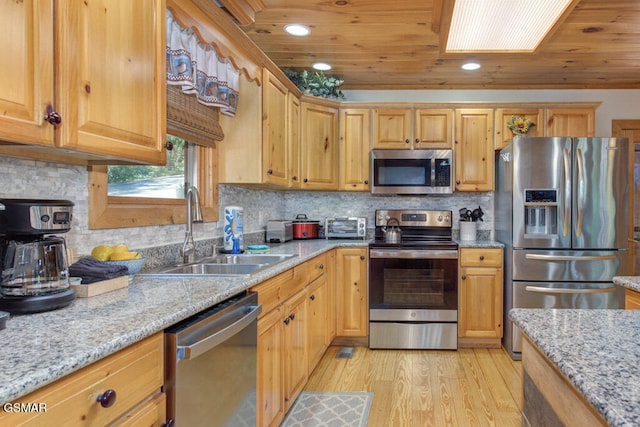 kitchen with sink, wood ceiling, appliances with stainless steel finishes, light stone countertops, and light hardwood / wood-style floors