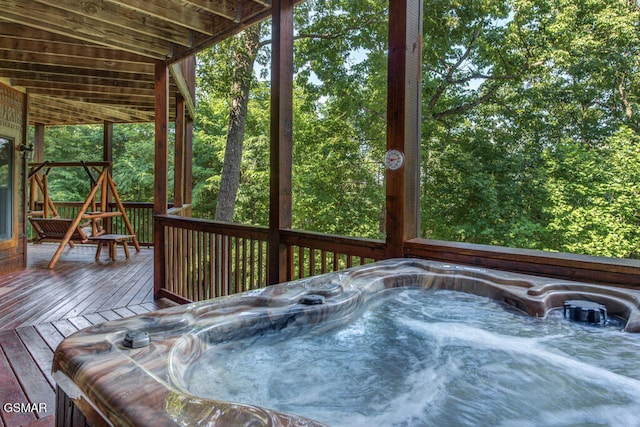 wooden deck with a hot tub