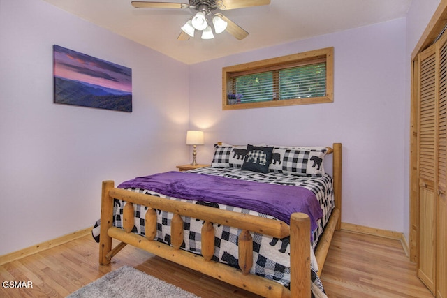 bedroom with light hardwood / wood-style floors, a closet, and ceiling fan