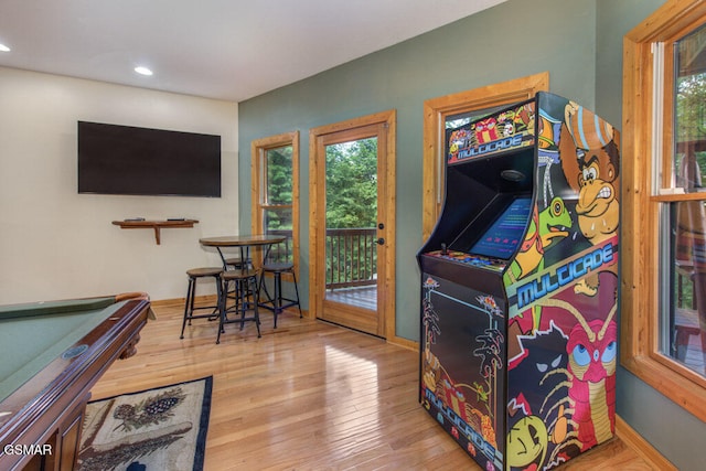 rec room with hardwood / wood-style floors, billiards, and a healthy amount of sunlight