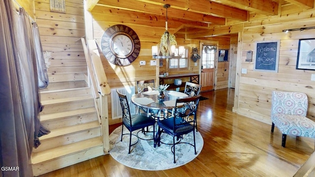 2022 Starr Crest Dr, Sevierville, TN 37876 - dining area with wood walls, hardwood / wood-style flooring, beam ceiling, a chandelier, and stairway