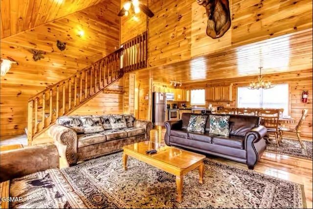 929 Smoky Ct, Gatlinburg, TN 37738 - living area with wood walls, stairway, wood finished floors, wood ceiling, and a chandelier