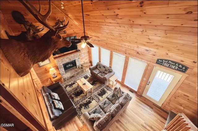 929 Smoky Ct, Gatlinburg, TN 37738 - living room with ceiling fan, wooden walls, a fireplace, and wood finished floors