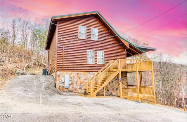 929 Smoky Ct, Gatlinburg, TN 37738 - view of front of home with stone siding, stairway, and a wooden deck