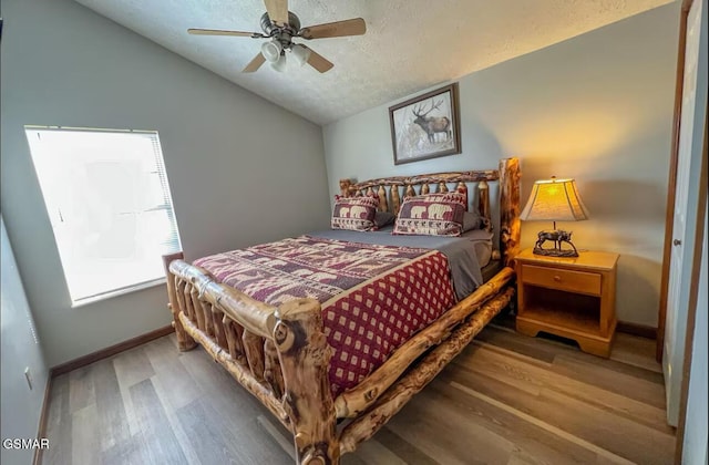 929 Smoky Ct, Gatlinburg, TN 37738 - bedroom featuring vaulted ceiling, wood finished floors, baseboards, a textured ceiling, and a ceiling fan