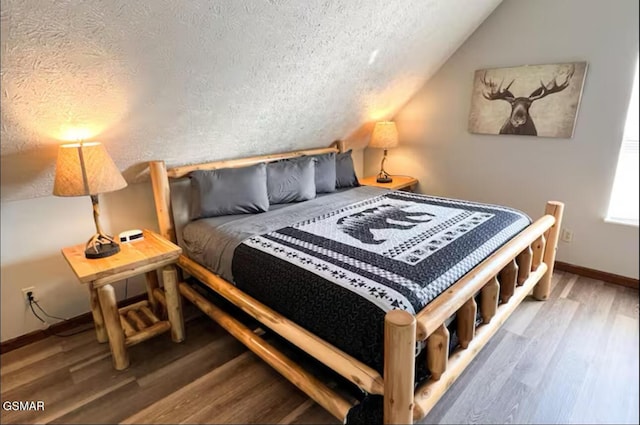 929 Smoky Ct, Gatlinburg, TN 37738 - bedroom with a textured ceiling, baseboards, wood finished floors, and lofted ceiling