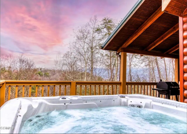 929 Smoky Ct, Gatlinburg, TN 37738 - deck at dusk with a hot tub and area for grilling