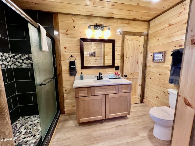 bathroom featuring wooden ceiling, walk in shower, wood walls, vanity, and hardwood / wood-style flooring