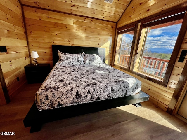 bedroom featuring wooden walls, dark hardwood / wood-style flooring, wooden ceiling, and vaulted ceiling