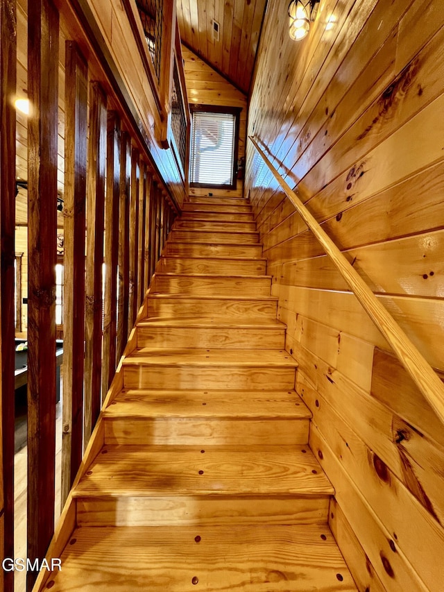 stairway with wooden ceiling