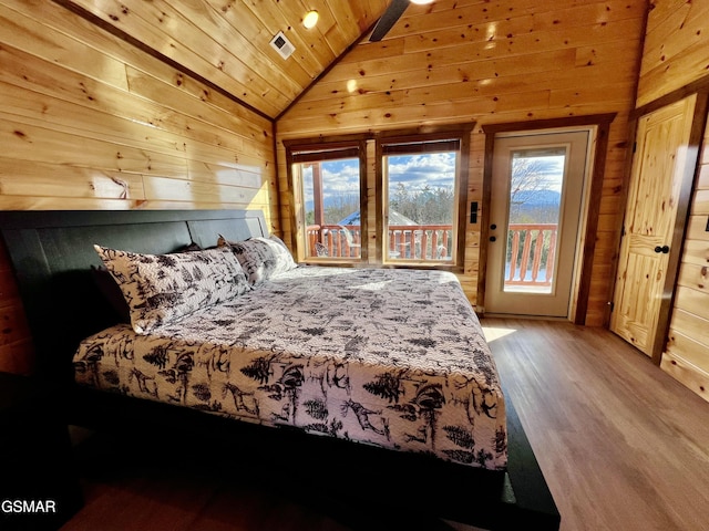 bedroom featuring access to exterior, wooden ceiling, high vaulted ceiling, hardwood / wood-style floors, and wooden walls