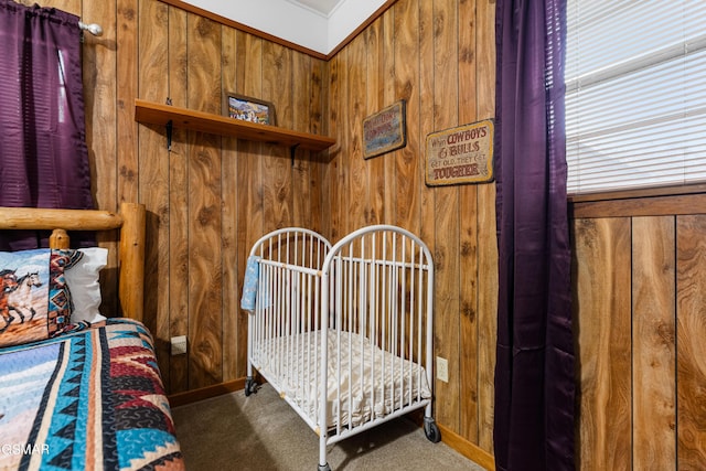 carpeted bedroom with wood walls