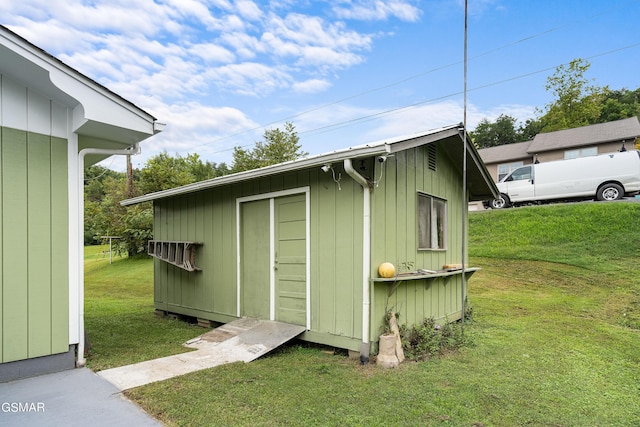 view of outbuilding with a lawn