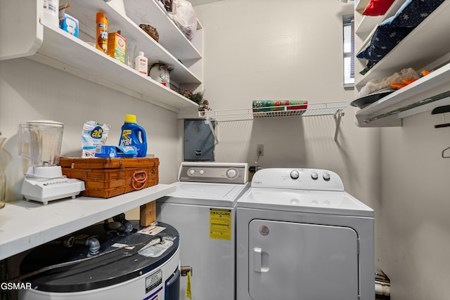 laundry room with separate washer and dryer and water heater