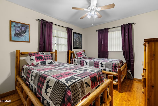 bedroom with hardwood / wood-style floors and ceiling fan