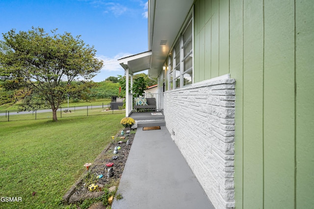 view of side of property with a lawn