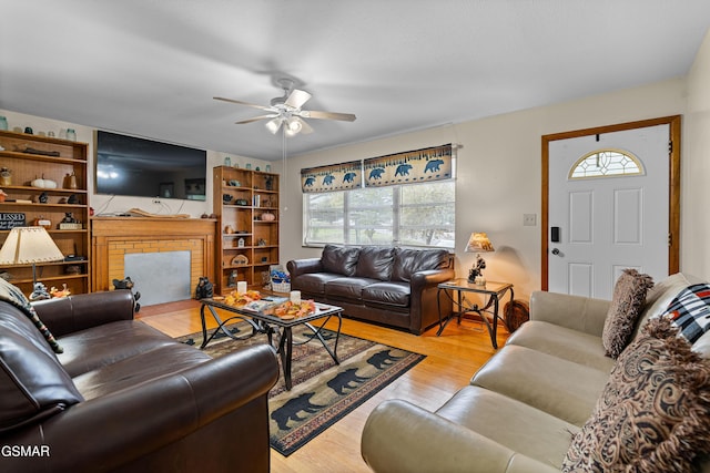 living room with ceiling fan and light wood-type flooring