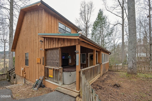 view of side of home featuring a hot tub