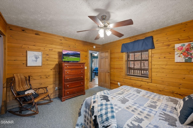 carpeted bedroom with ceiling fan and a textured ceiling