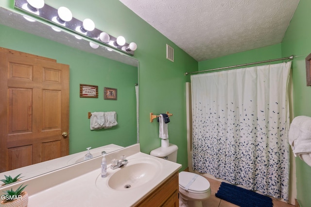 bathroom featuring vanity, toilet, a textured ceiling, and a shower with curtain