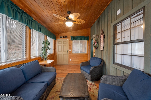 living room featuring lofted ceiling, wooden ceiling, wooden walls, hardwood / wood-style flooring, and ceiling fan