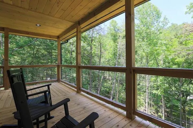 unfurnished sunroom with wooden ceiling