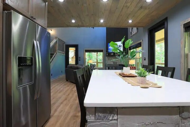 dining area with wood ceiling, plenty of natural light, and light hardwood / wood-style floors