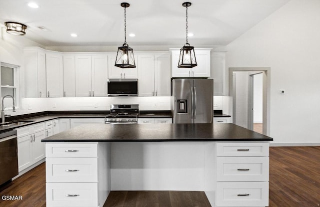1902 Kaylee Dr, Jefferson City, TN 37760 - kitchen featuring stainless steel appliances, a sink, dark countertops, dark wood-type flooring, and white cabinetry