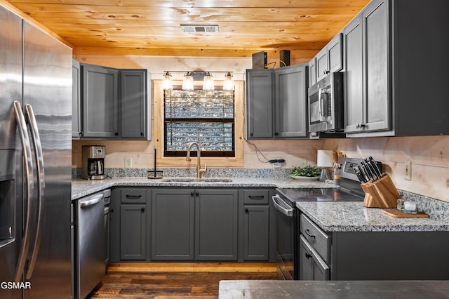 519 Mcmahan Rd, Pigeon Forge, TN 37863 - kitchen featuring stainless steel appliances, dark wood finished floors, wooden ceiling, light stone counters, and gray cabinets