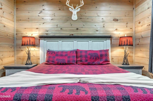 bedroom featuring wooden walls