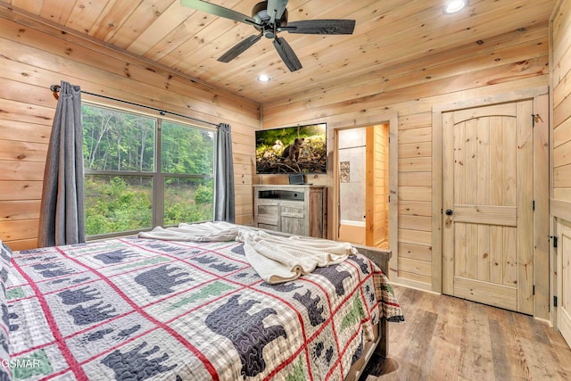 bedroom featuring wood ceiling, wood walls, recessed lighting, wood finished floors, and ensuite bath