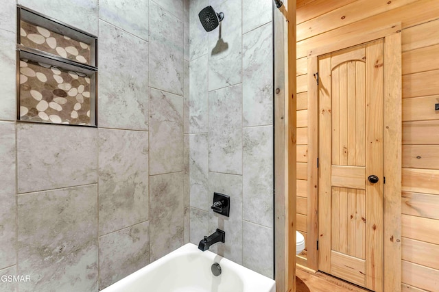 bathroom featuring toilet and shower / washtub combination