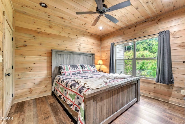 bedroom with wood-type flooring, wood walls, wood ceiling, recessed lighting, and ceiling fan